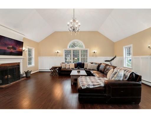 21 Valley View Circle Rutland, MA 01543 - Photo 9 of 40 a living room with furniture a fireplace and a chandelier