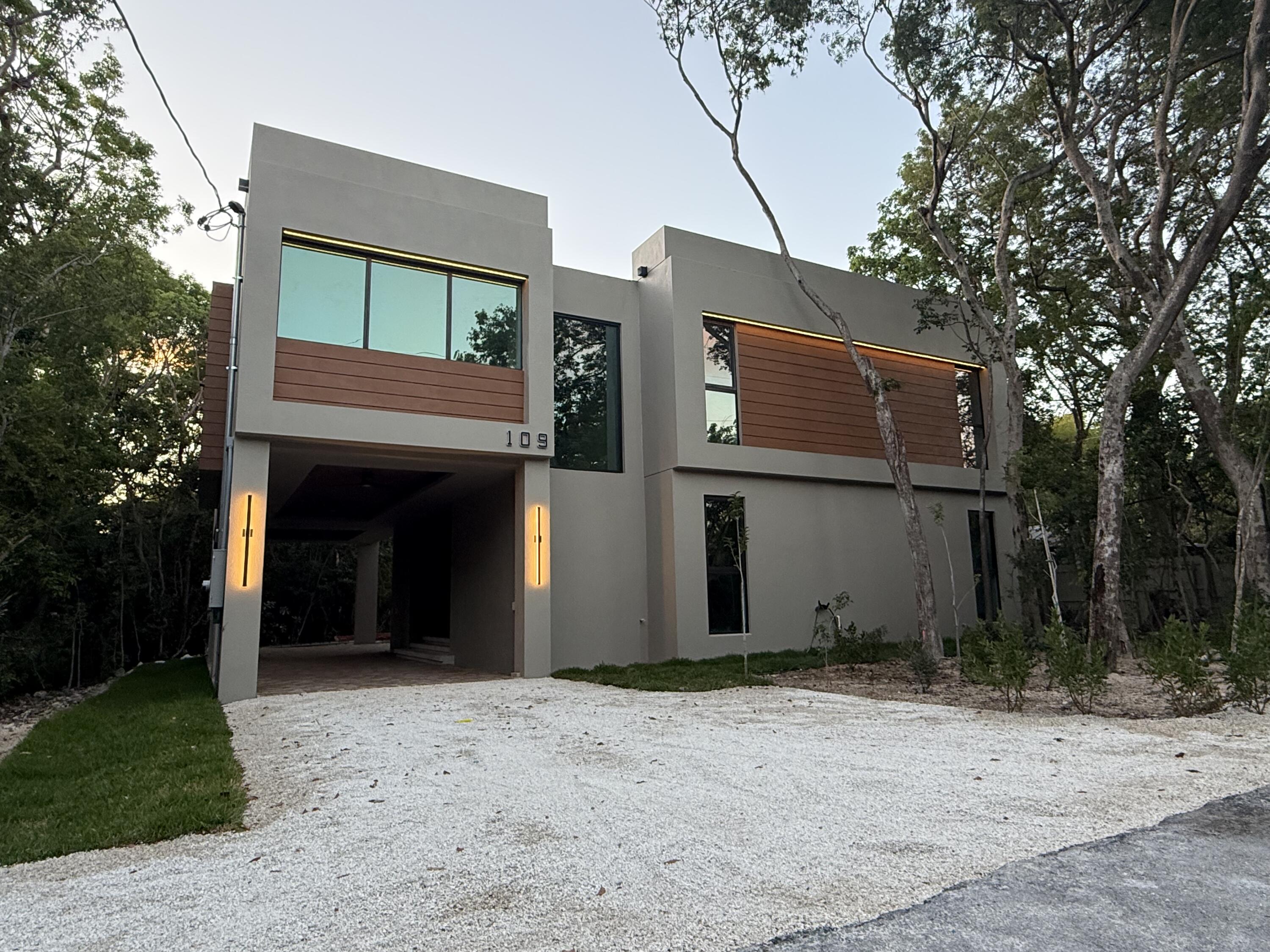 a view of a house with a yard and garage