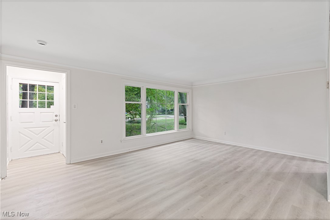1057 Renfield Road Cleveland Heights, OH 44121 - Photo 2 of 30 Spare room featuring a wealth of natural light, light hardwood / wood-style flooring, and ornamental molding