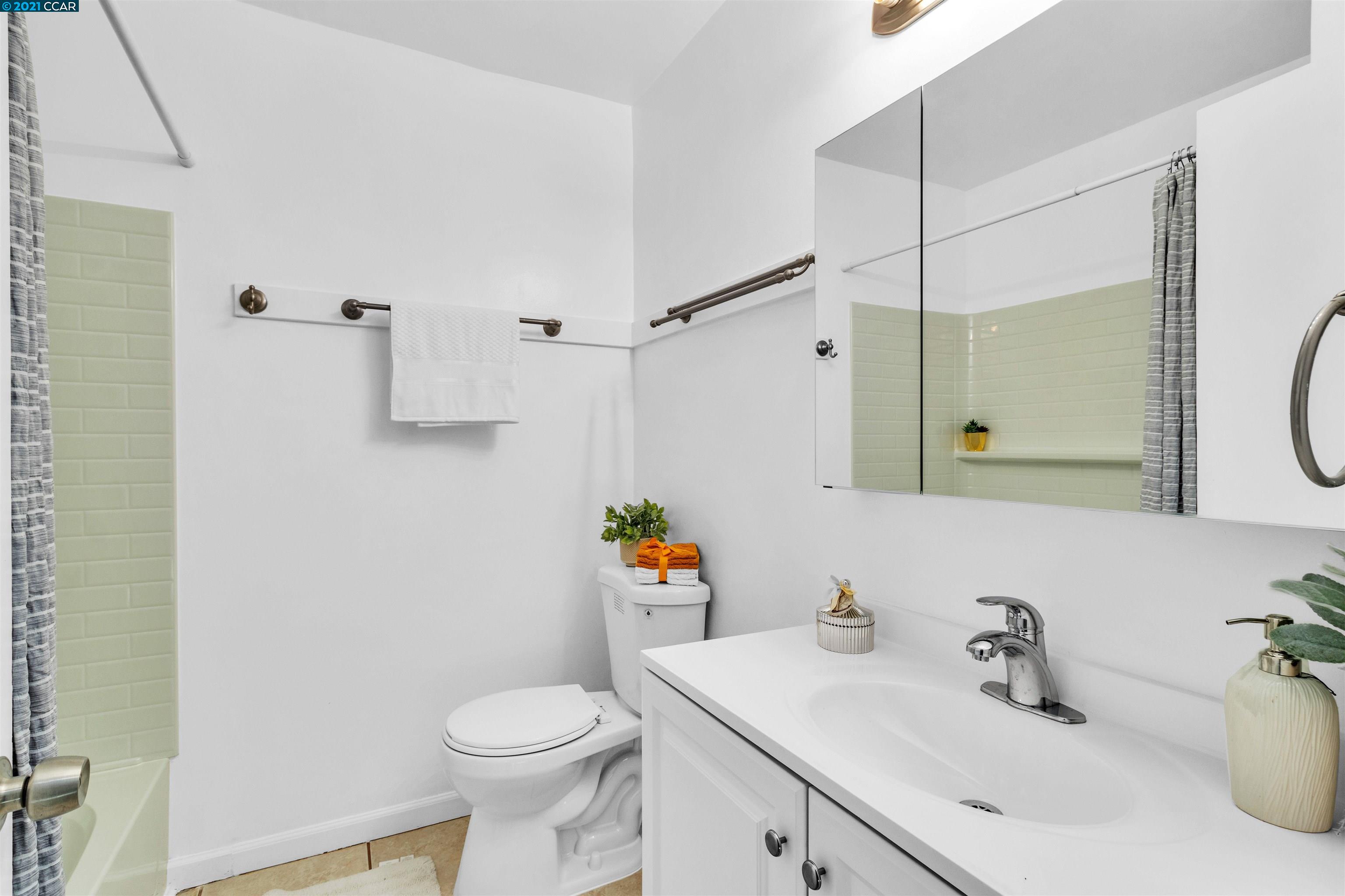 Herbert Guice Way Oakland, CA 94621 - Photo 11 of 40 a bathroom with a sink a toilet and a mirror