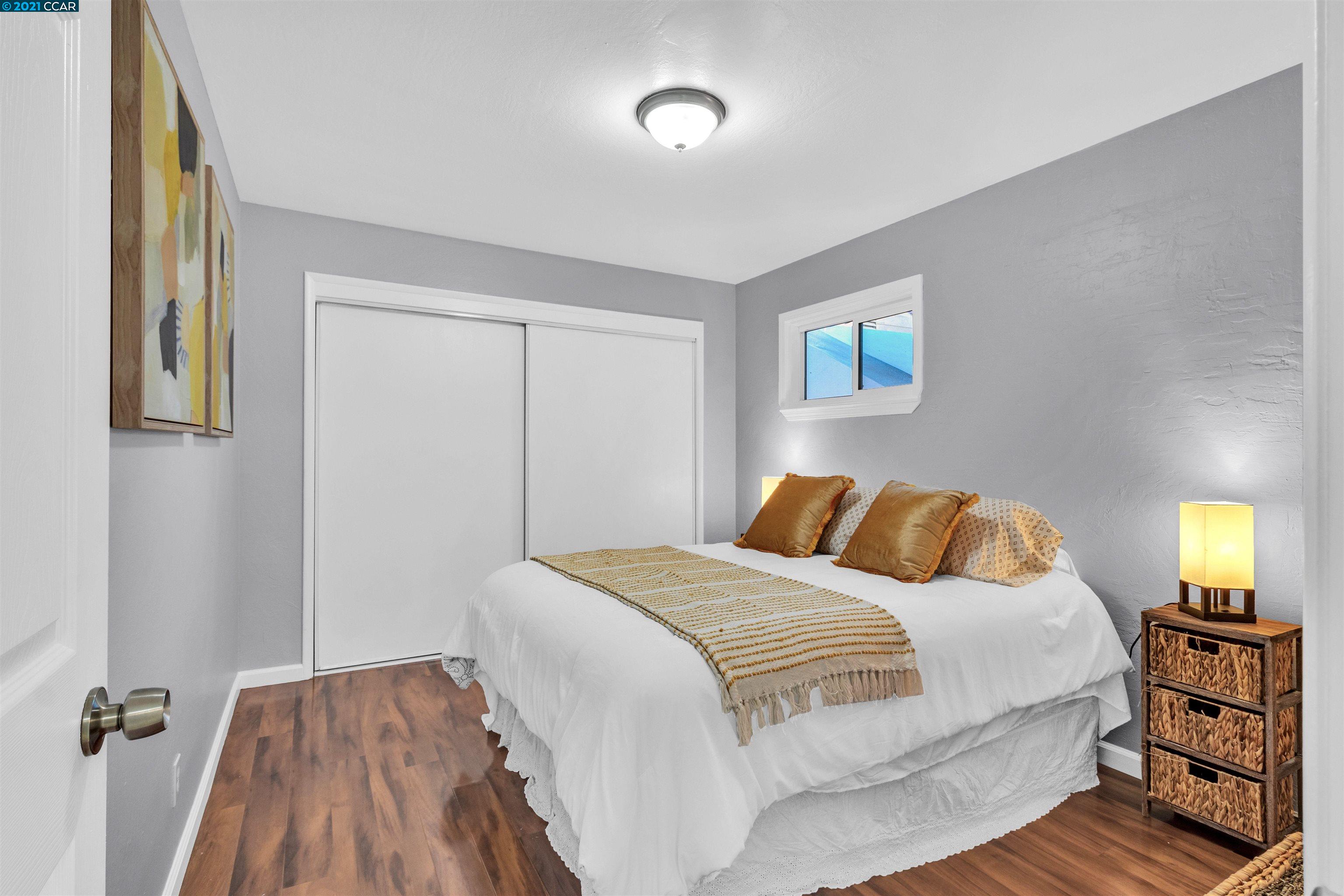 Herbert Guice Way Oakland, CA 94621 - Photo 12 of 40 a bedroom with a bed and wooden floor