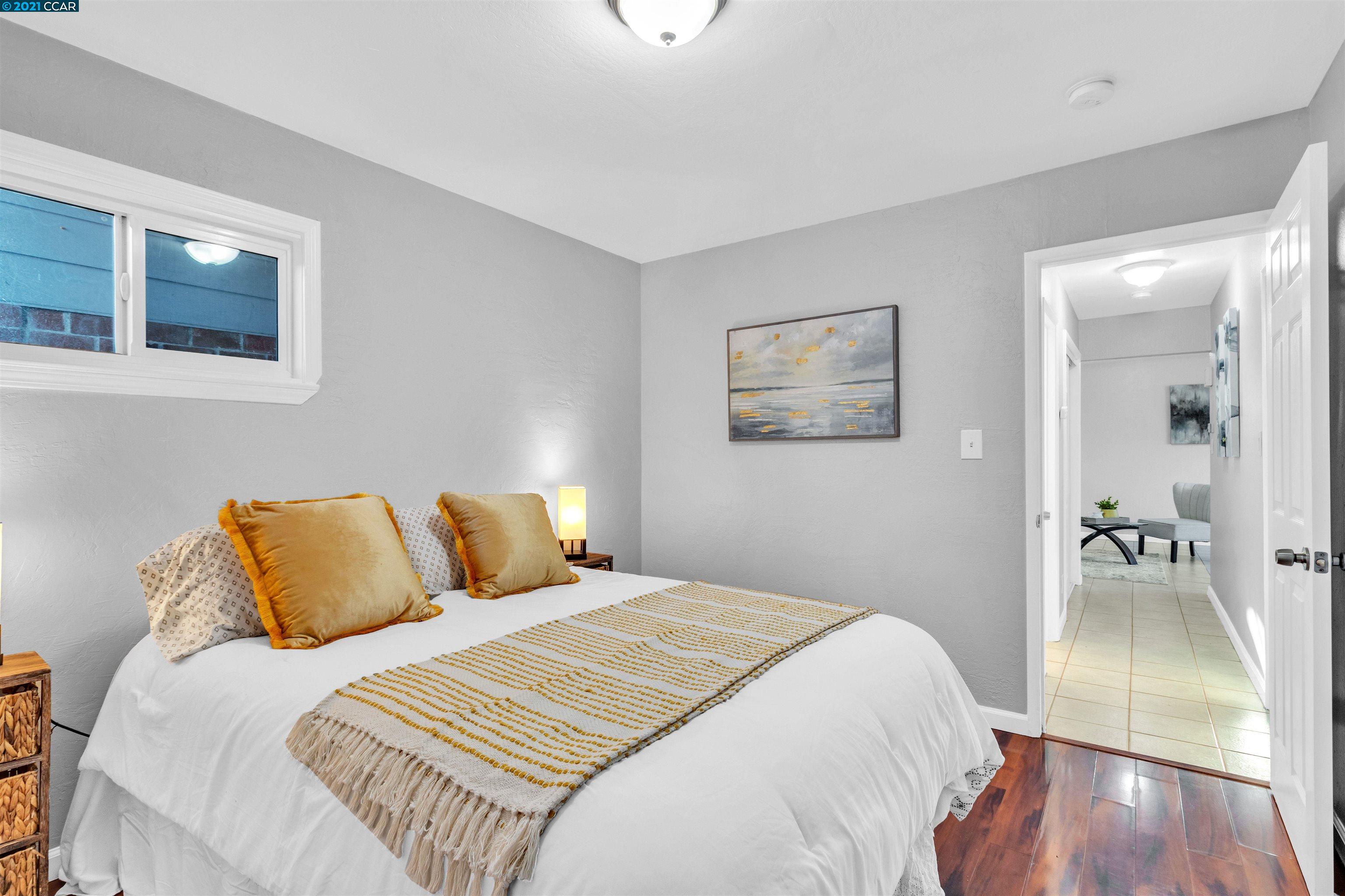 Herbert Guice Way Oakland, CA 94621 - Photo 13 of 40 a bedroom with a bed and a painting on the wall