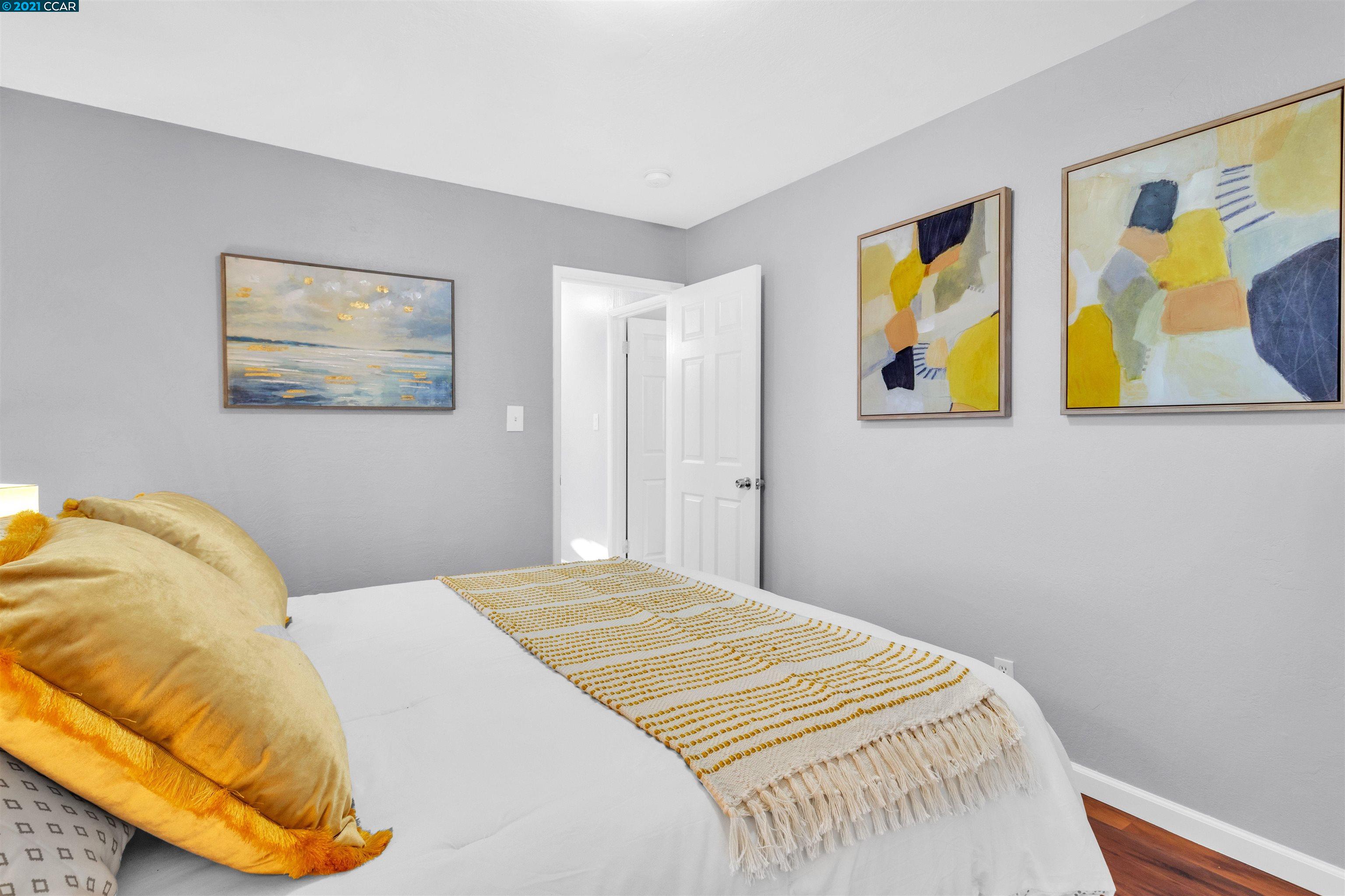 Herbert Guice Way Oakland, CA 94621 - Photo 14 of 40 a bedroom with a bed and cupboard