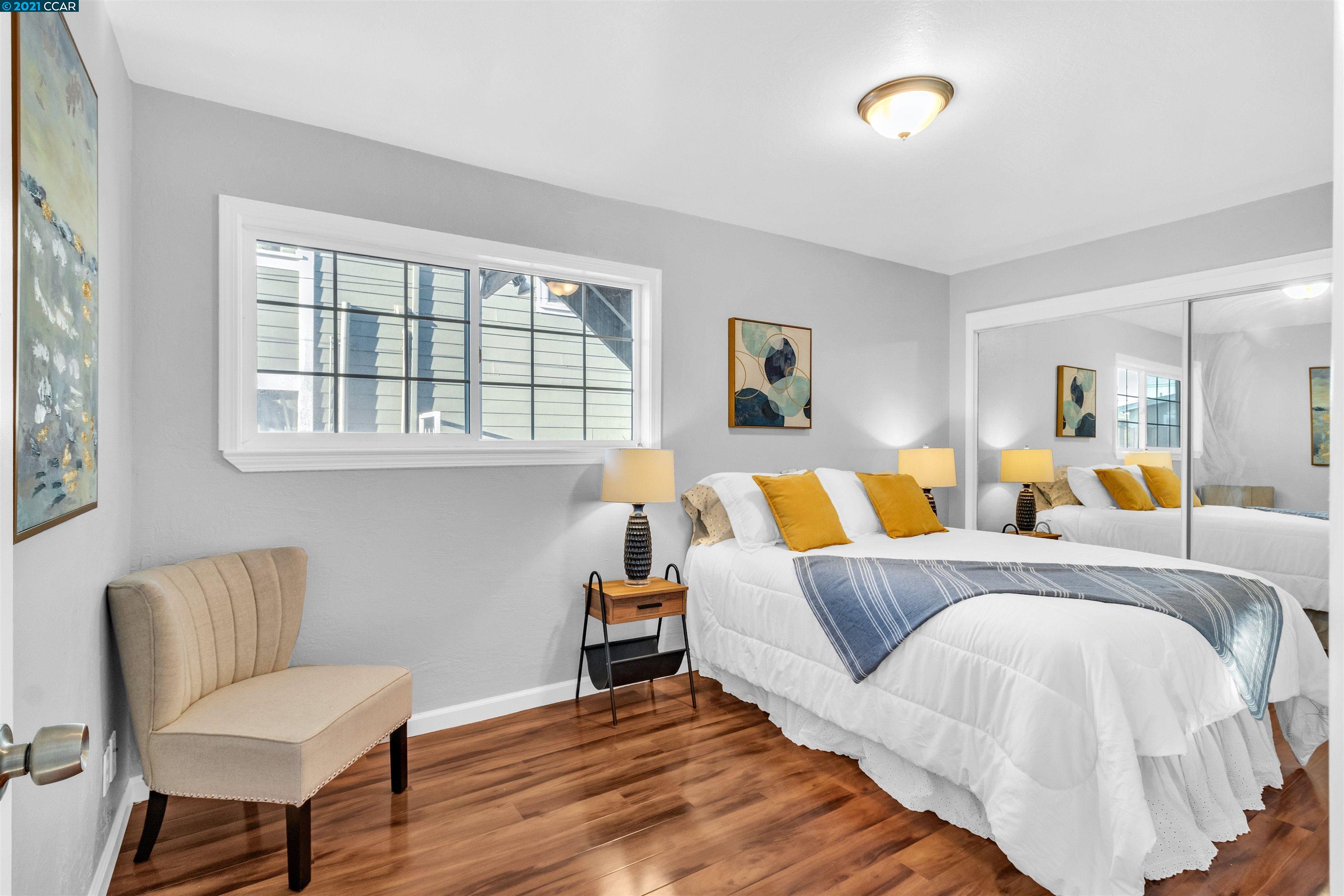 Herbert Guice Way Oakland, CA 94621 - Photo 15 of 40 a bed room with a bed and a chair