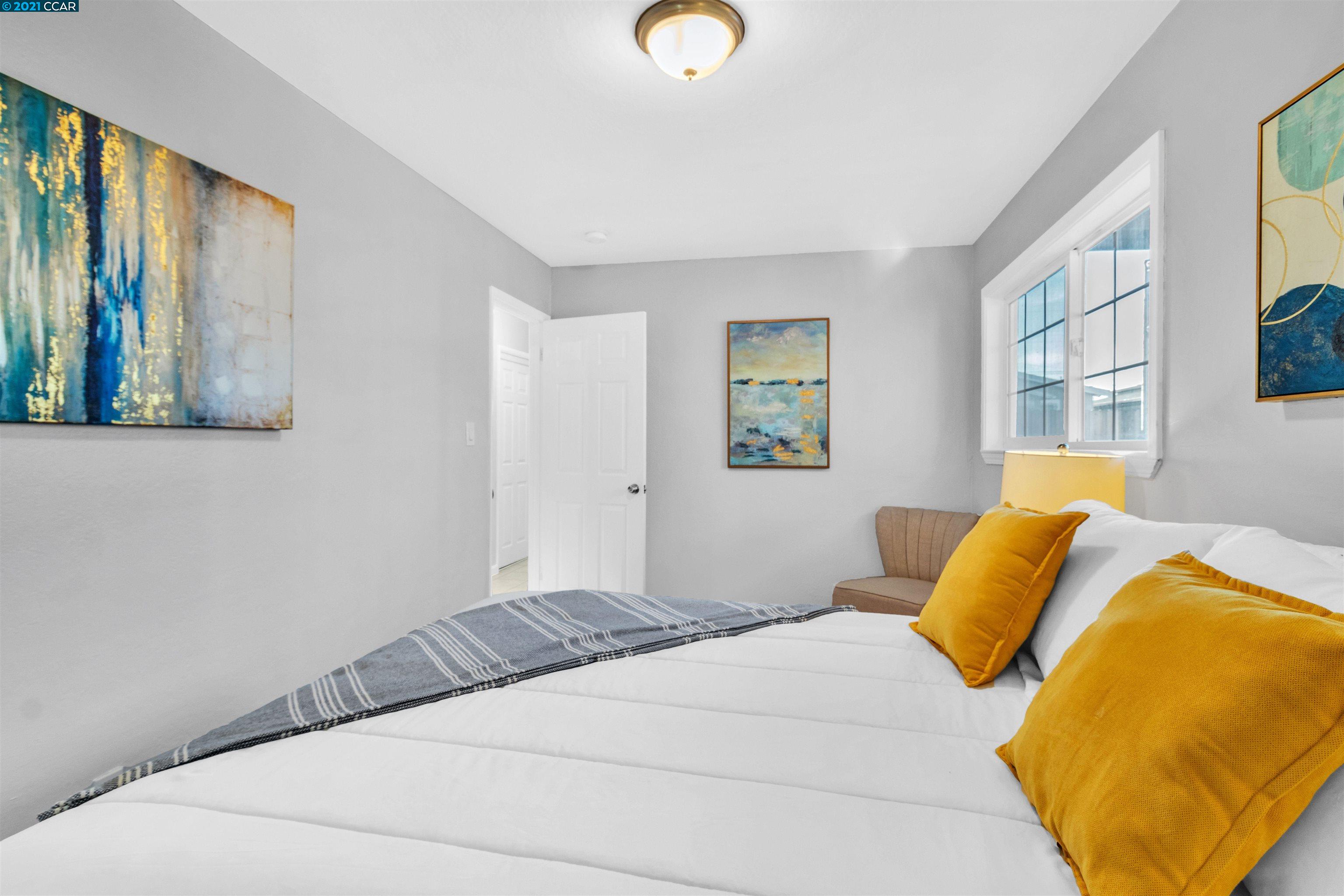 Herbert Guice Way Oakland, CA 94621 - Photo 16 of 40 a bedroom with a bed and painting on the wall