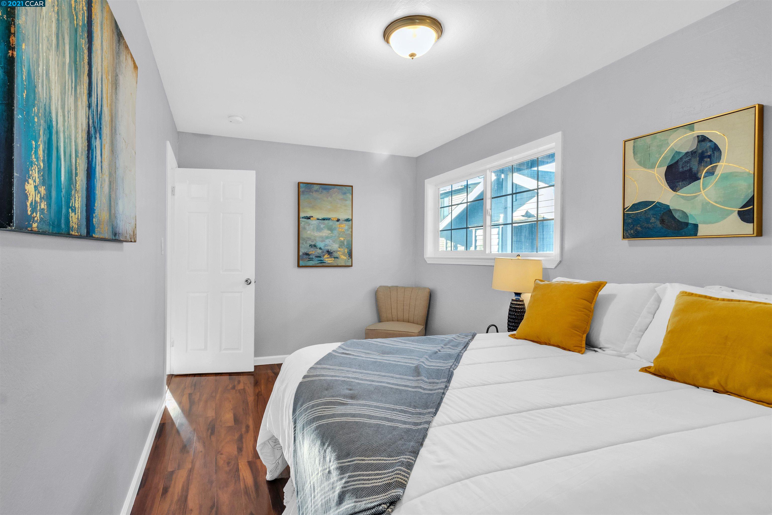 Herbert Guice Way Oakland, CA 94621 - Photo 17 of 40 a bedroom with a bed and painting on the wall