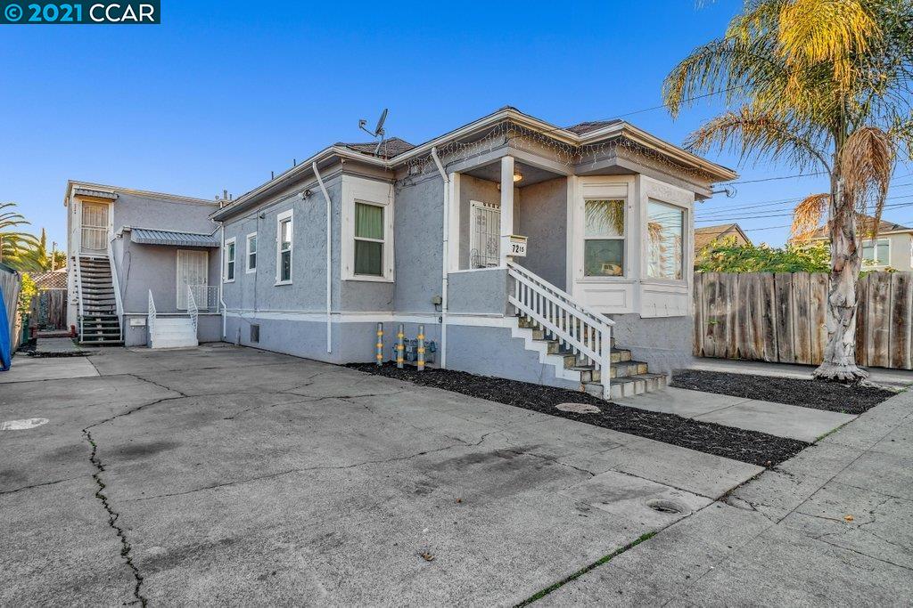 Herbert Guice Way Oakland, CA 94621 - Photo 21 of 40 a front view of a house with a yard and garage