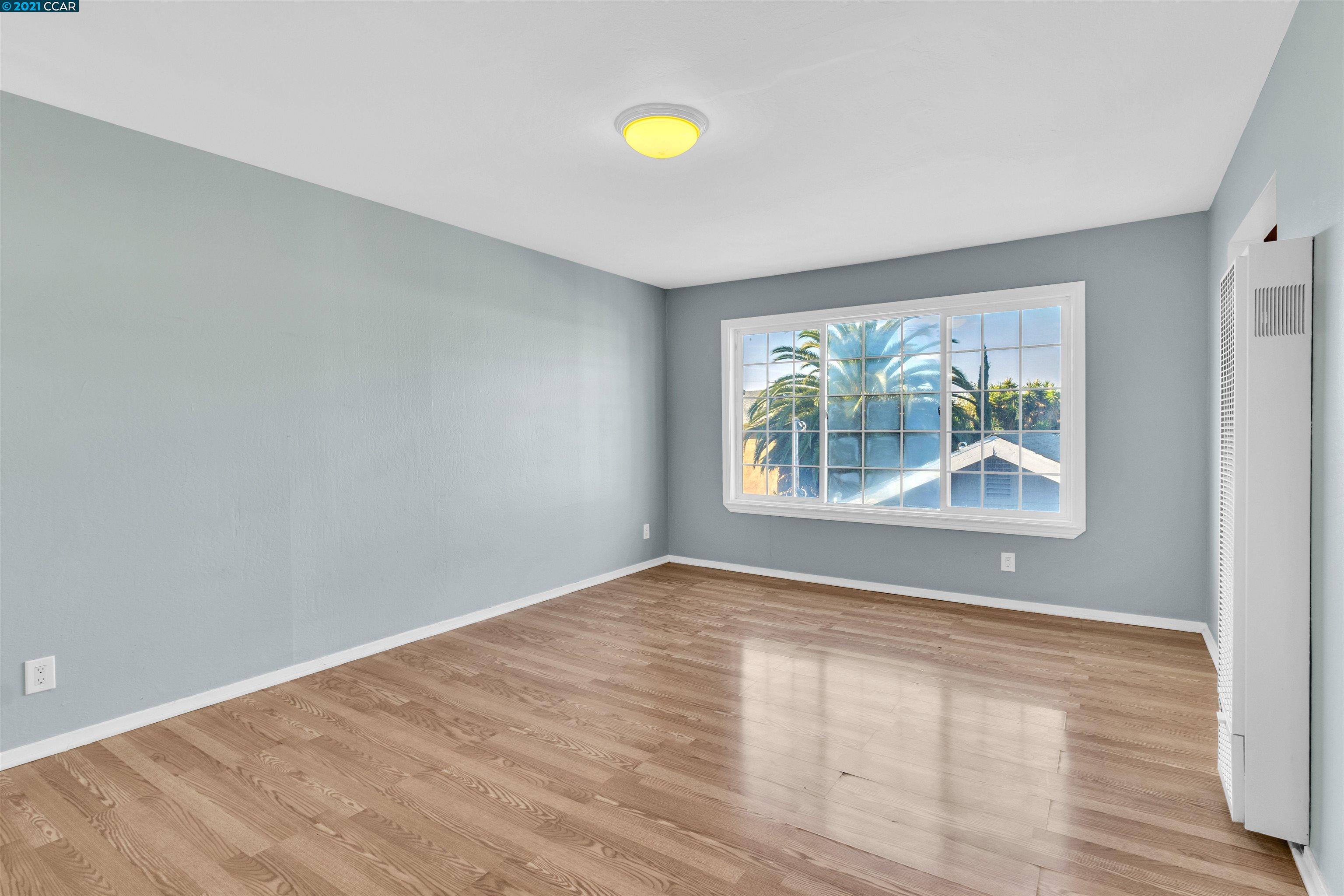 Herbert Guice Way Oakland, CA 94621 - Photo 22 of 40 a view of an empty room with window and wooden floor