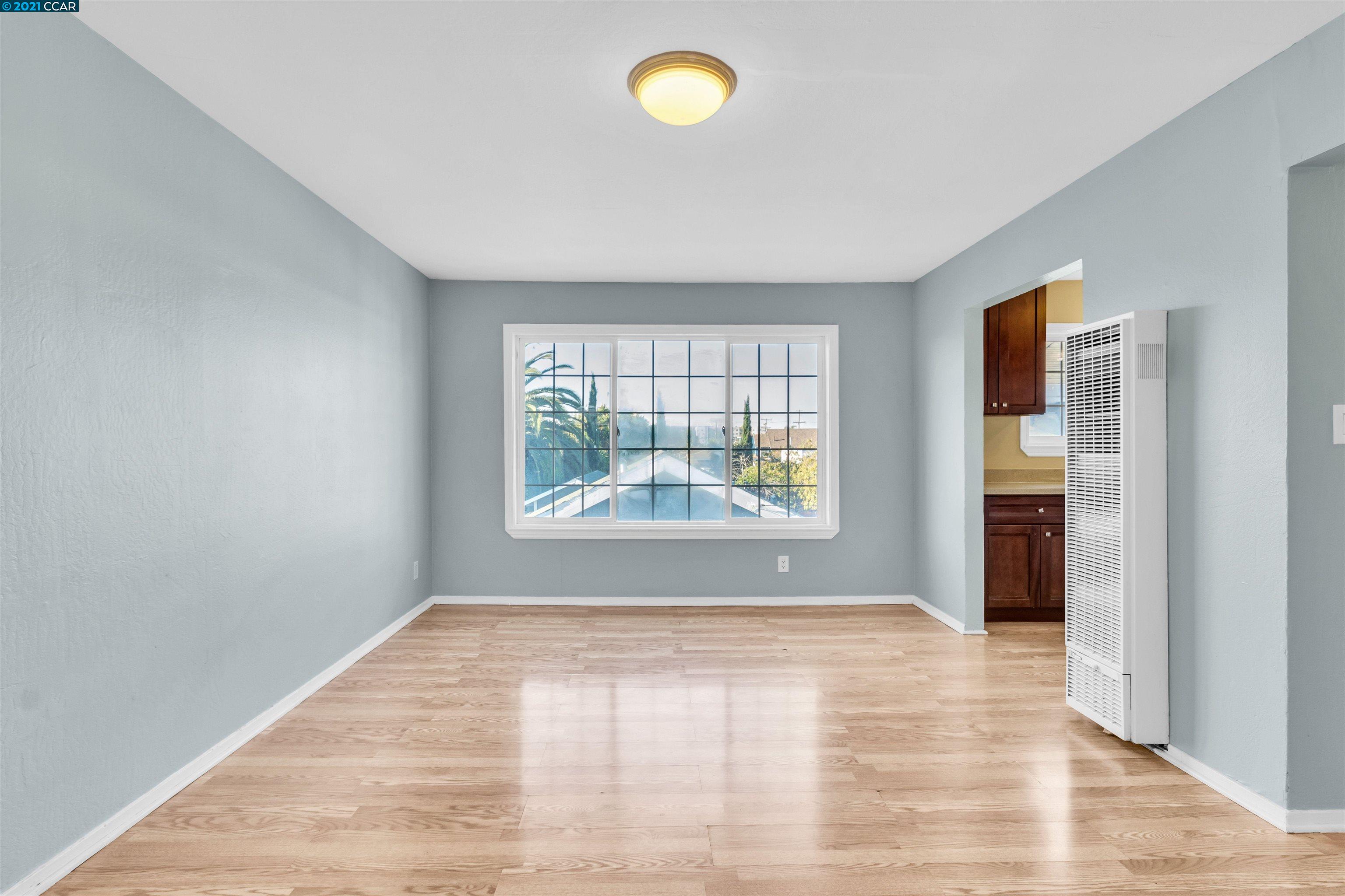 Herbert Guice Way Oakland, CA 94621 - Photo 23 of 40 wooden floor in an empty room with a window