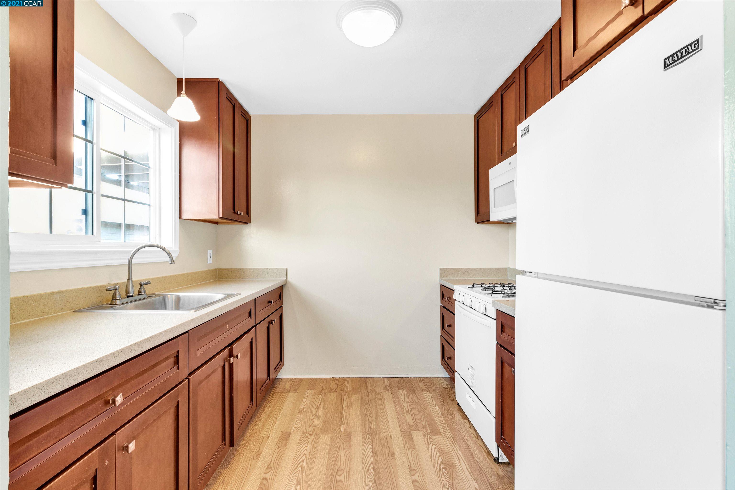 Herbert Guice Way Oakland, CA 94621 - Photo 25 of 40 a hallway with sink and mirror