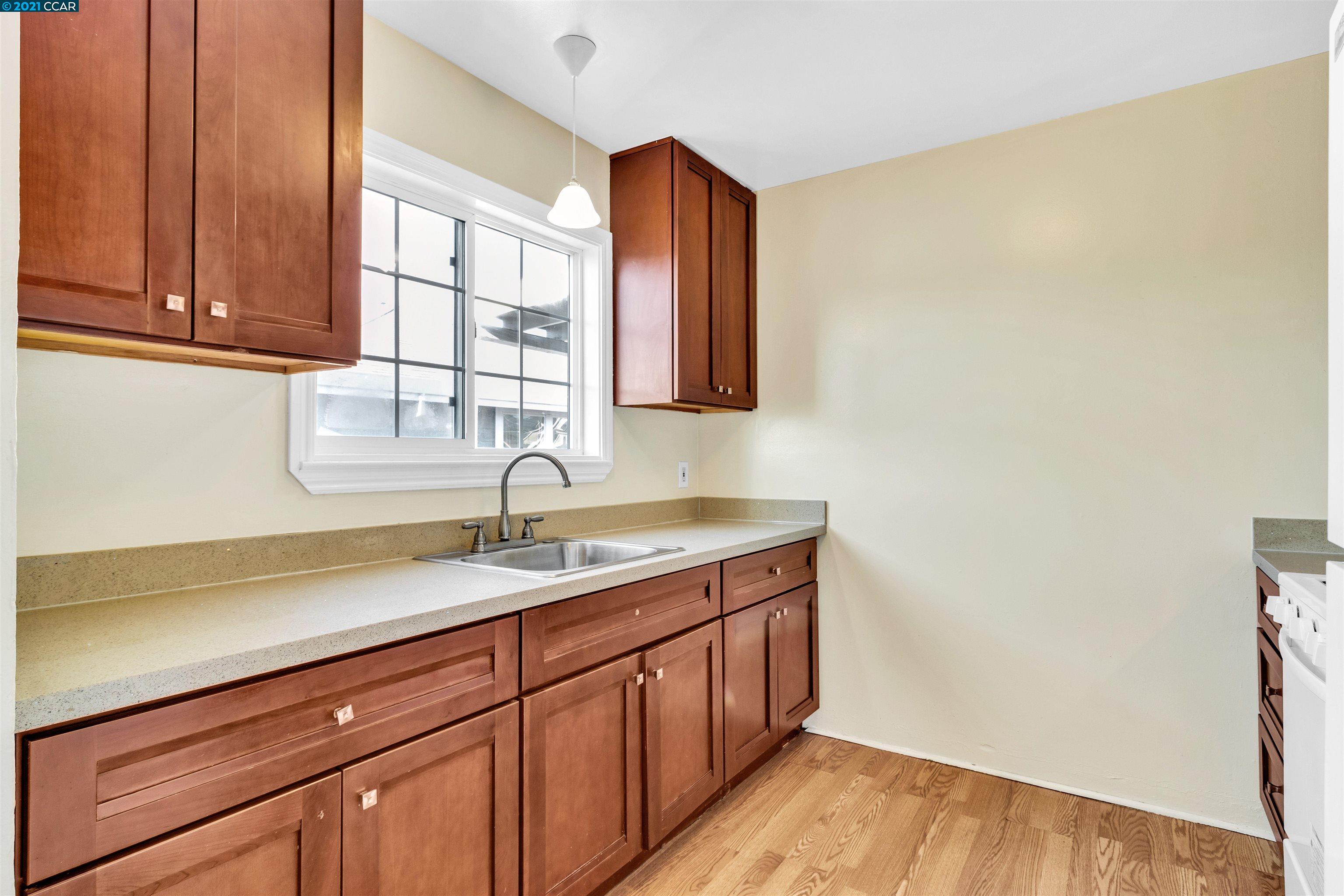 Herbert Guice Way Oakland, CA 94621 - Photo 26 of 40 a kitchen with a sink and cabinets