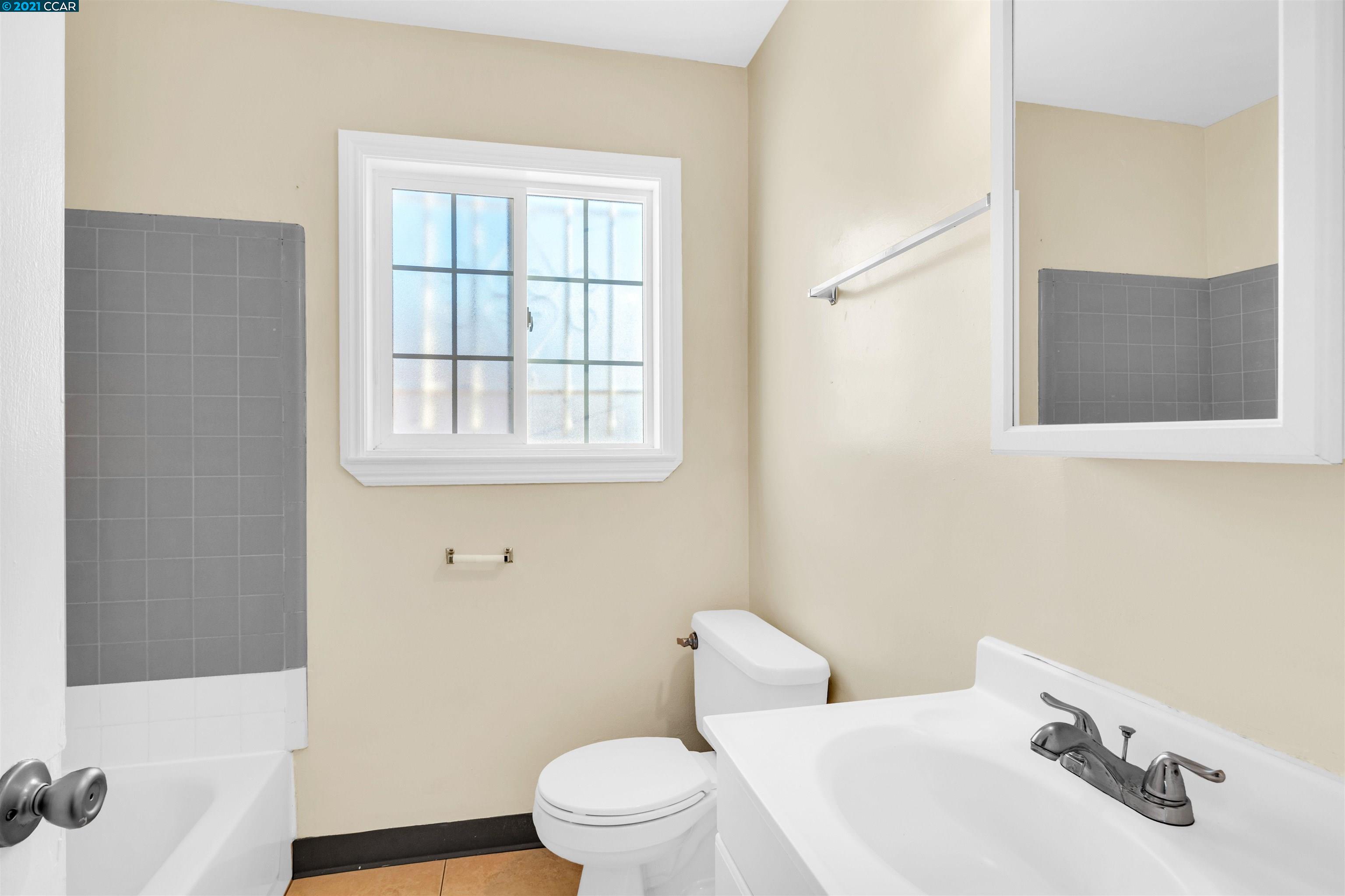 Herbert Guice Way Oakland, CA 94621 - Photo 27 of 40 a white toilet sitting next to a bathroom sink