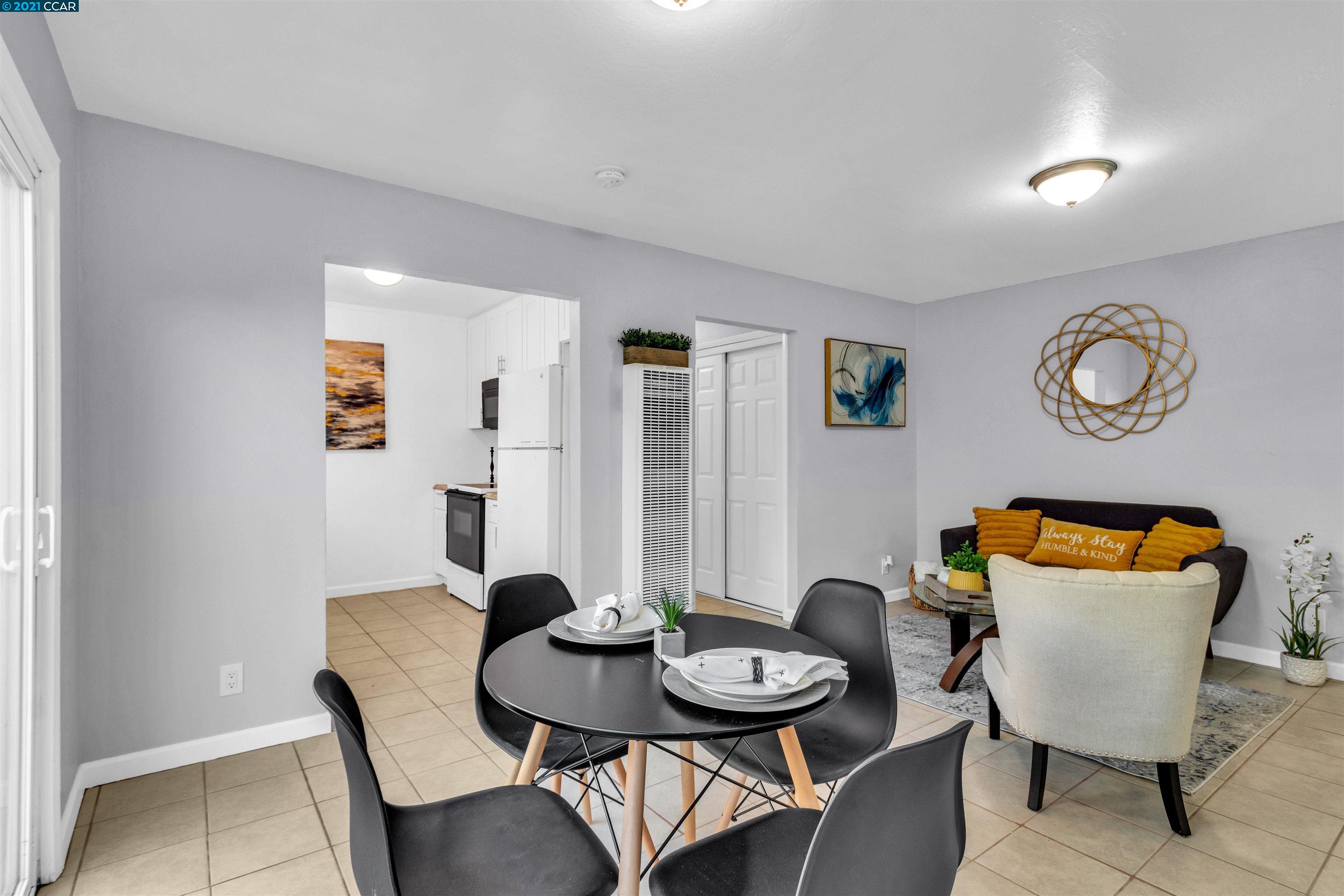 Herbert Guice Way Oakland, CA 94621 - Photo 3 of 40 a view of a dining room with furniture and wooden floor