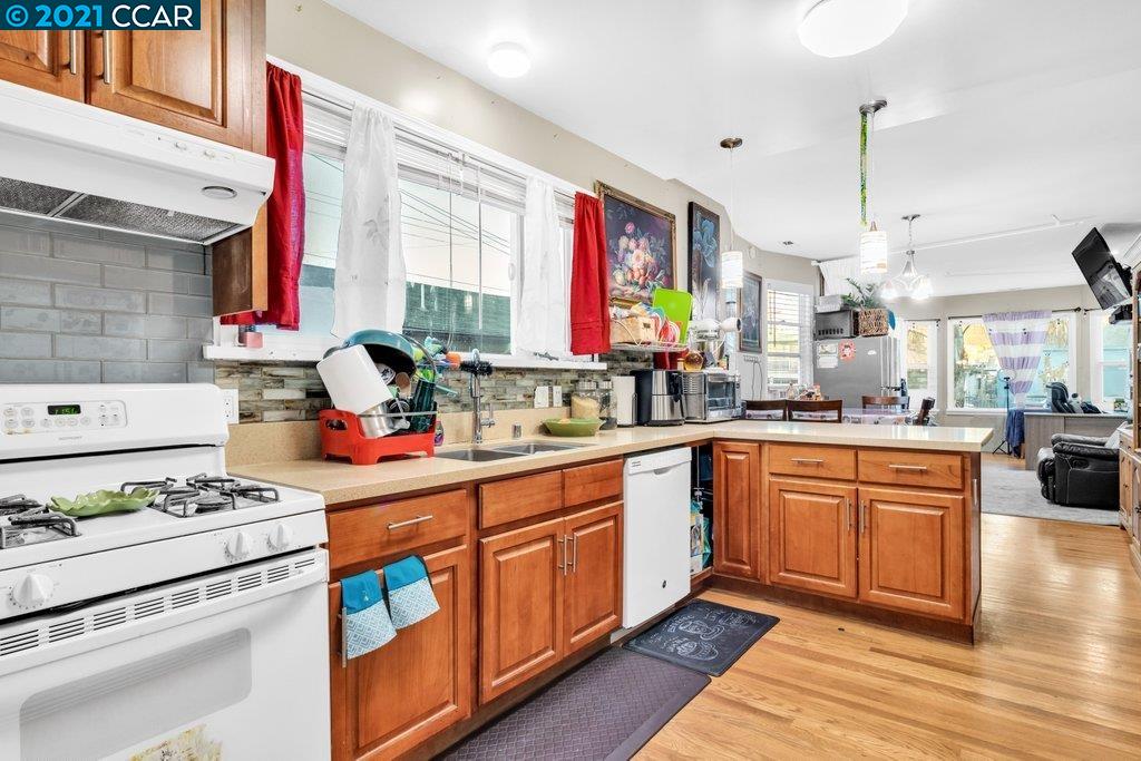 Herbert Guice Way Oakland, CA 94621 - Photo 36 of 40 a kitchen with stainless steel appliances kitchen island granite countertop a stove a sink and a microwave