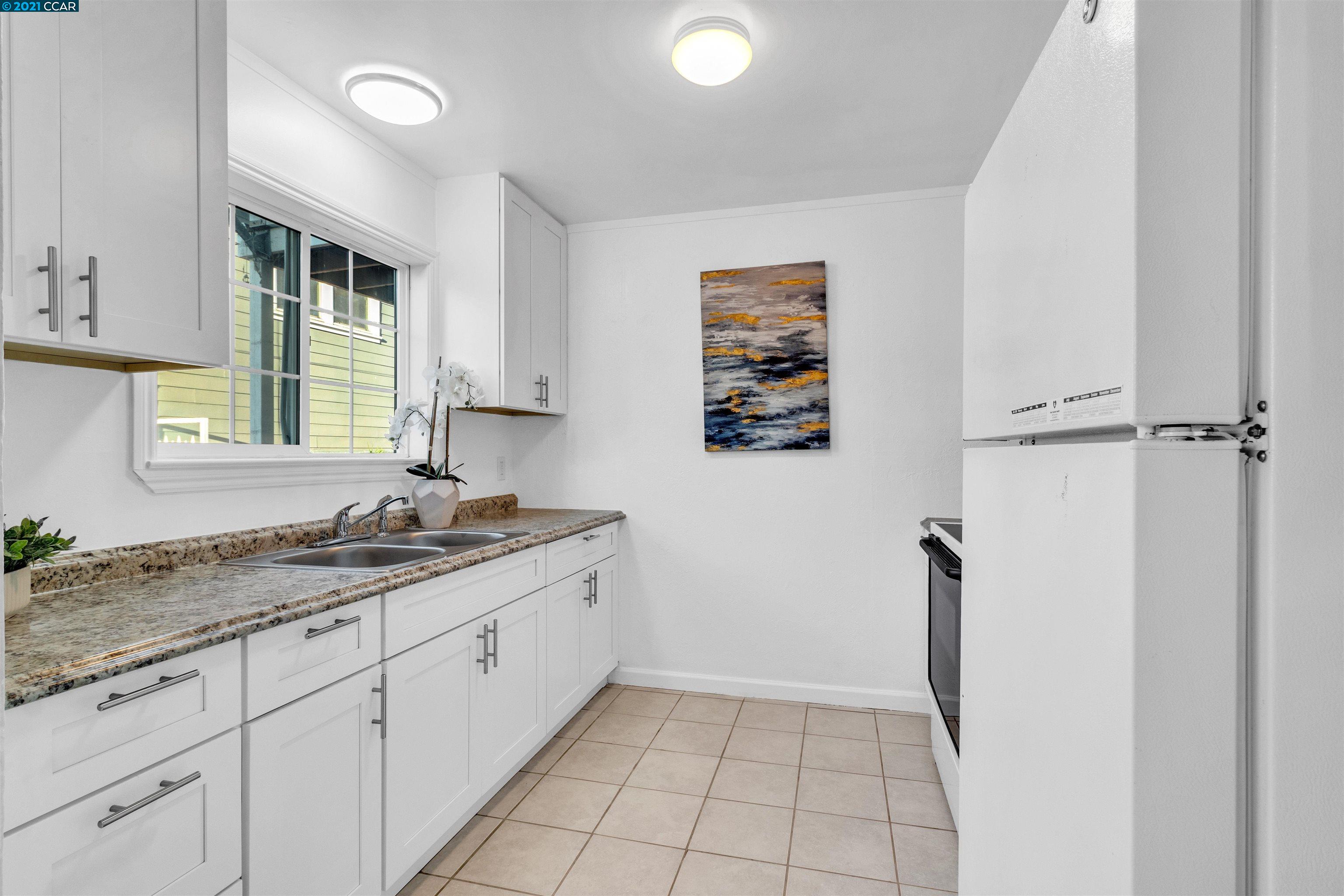 Herbert Guice Way Oakland, CA 94621 - Photo 7 of 40 a bathroom with a granite countertop sink a window and a mirror