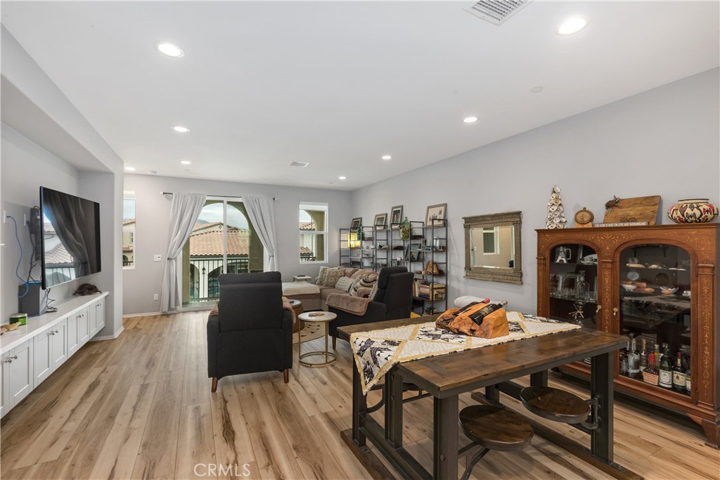 31329 Via Nubes Temecula, CA 92592 - Photo 12 of 45 a view of a dining room with furniture a chandelier and wooden floor