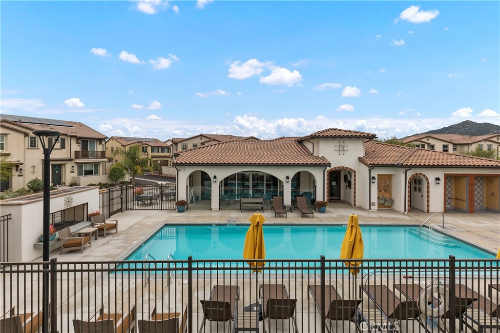 31329 Via Nubes Temecula, CA 92592 - Photo 18 of 45 a view of a brick house with a small yard and potted plants
