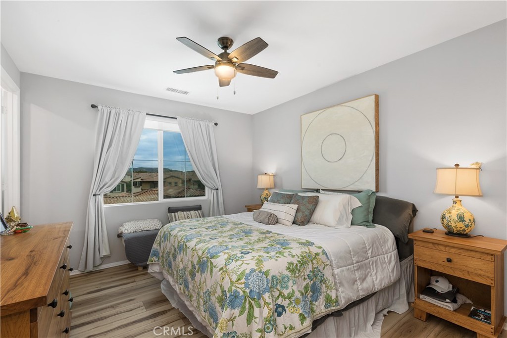 31329 Via Nubes Temecula, CA 92592 - Photo 19 of 45 a bedroom with a bed and a chandelier