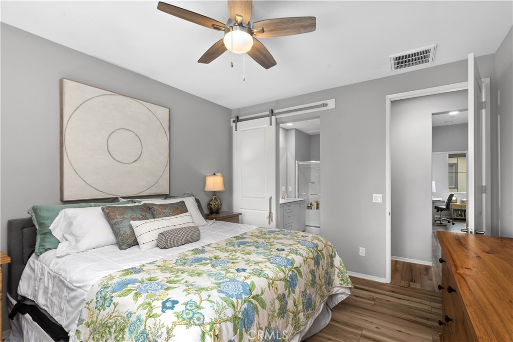 31329 Via Nubes Temecula, CA 92592 - Photo 20 of 45 a bedroom with bed and wooden floor