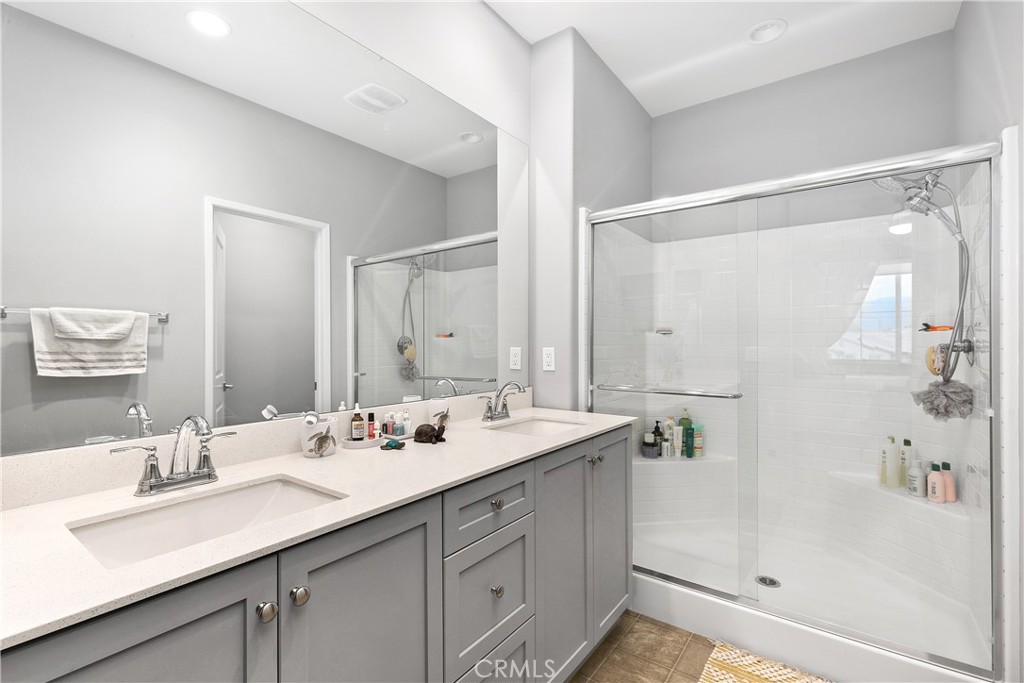 31329 Via Nubes Temecula, CA 92592 - Photo 21 of 45 a bathroom with a sink double vanity mirror and shower