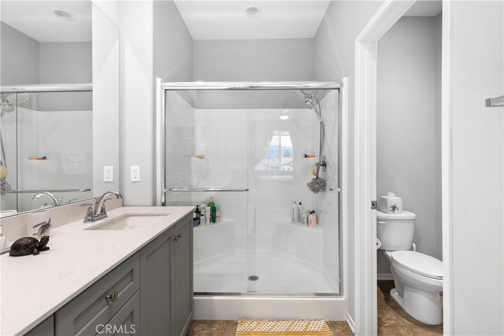 31329 Via Nubes Temecula, CA 92592 - Photo 22 of 45 a bathroom with a sink a toilet and shower