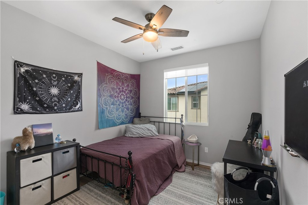 31329 Via Nubes Temecula, CA 92592 - Photo 25 of 45 a bedroom with a bed and wooden floor