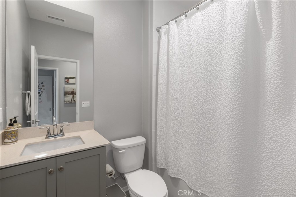 31329 Via Nubes Temecula, CA 92592 - Photo 26 of 45 a bathroom with a toilet a sink and mirror