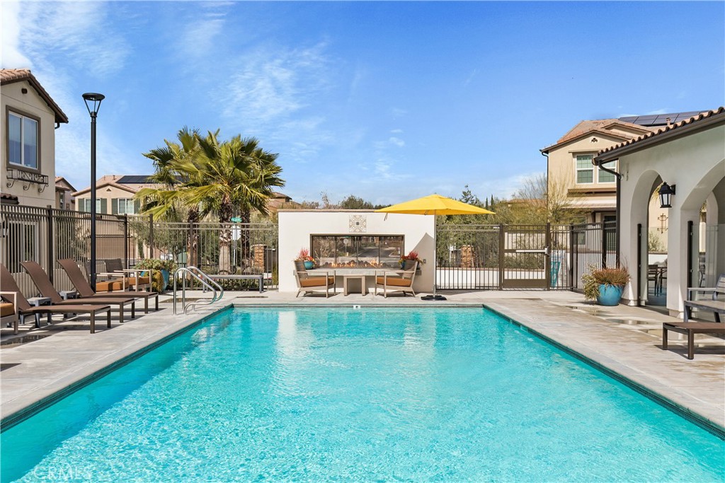 31329 Via Nubes Temecula, CA 92592 - Photo 34 of 45 a view of a swimming pool with lawn chairs and a yard