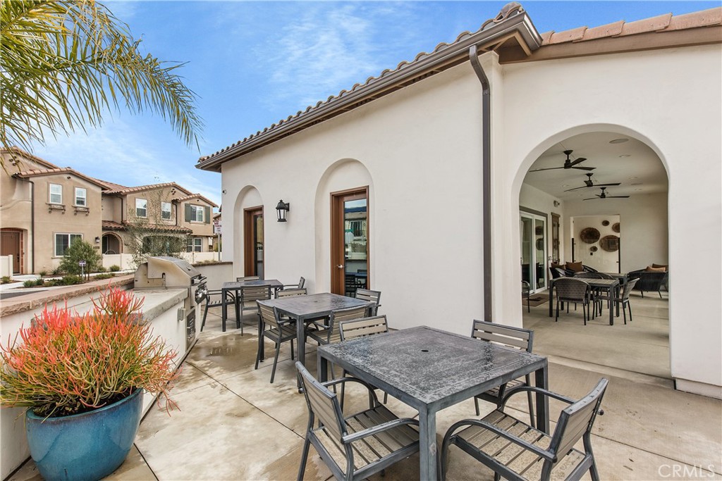 31329 Via Nubes Temecula, CA 92592 - Photo 36 of 45 a view of a patio with table and chairs potted plants and a large tree