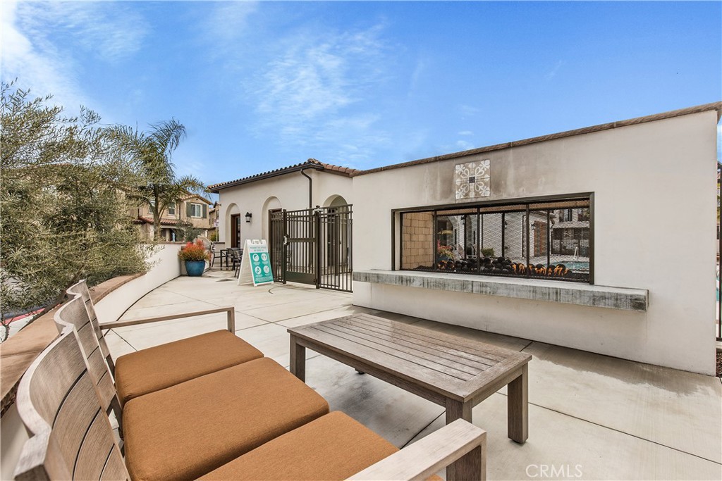31329 Via Nubes Temecula, CA 92592 - Photo 37 of 45 a view of a patio with couches and table and chairs with wooden floor and fence