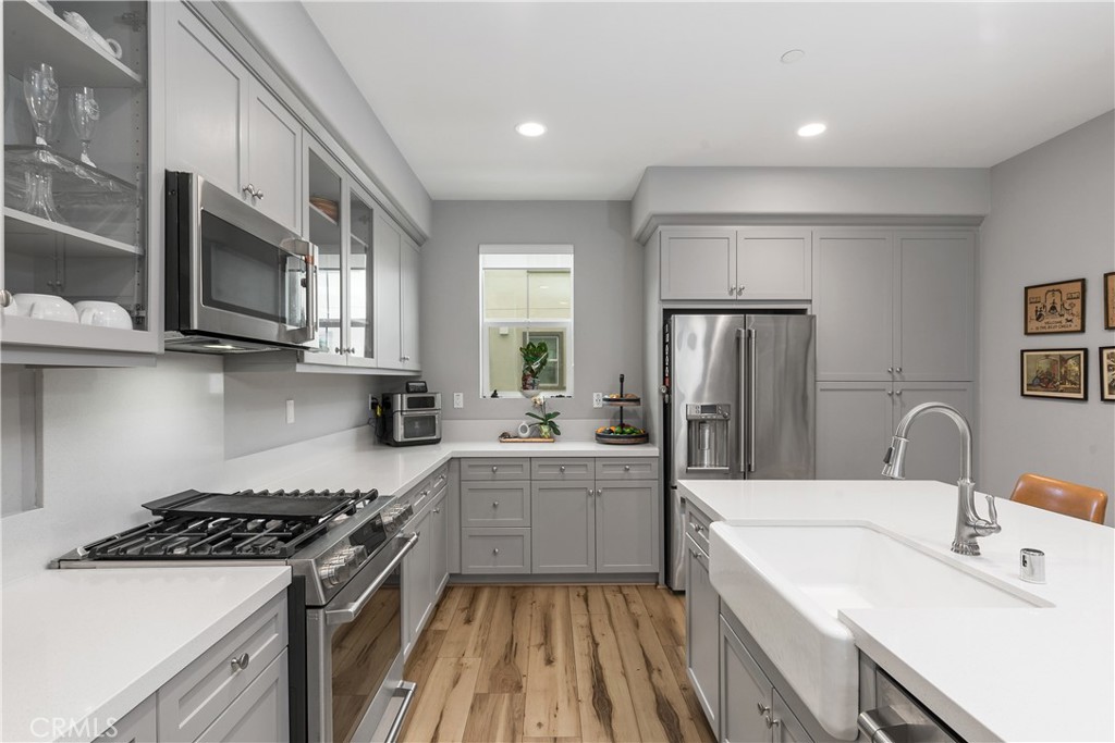 31329 Via Nubes Temecula, CA 92592 - Photo 7 of 45 a kitchen with stainless steel appliances a sink stove and refrigerator