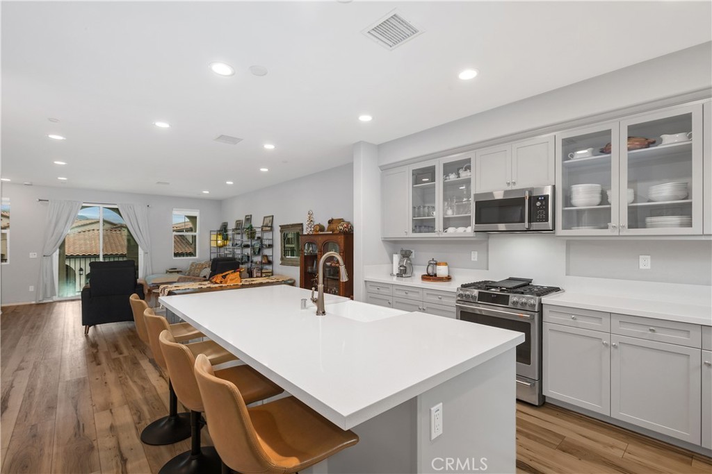 31329 Via Nubes Temecula, CA 92592 - Photo 9 of 45 a kitchen with a stove a refrigerator and a stove top oven