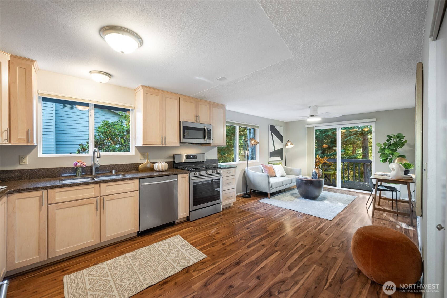 24431 11th Avenue South Des Moines, WA 98198 - Photo 14 of 39 a large white kitchen with cabinets a sink a window and a potted plant