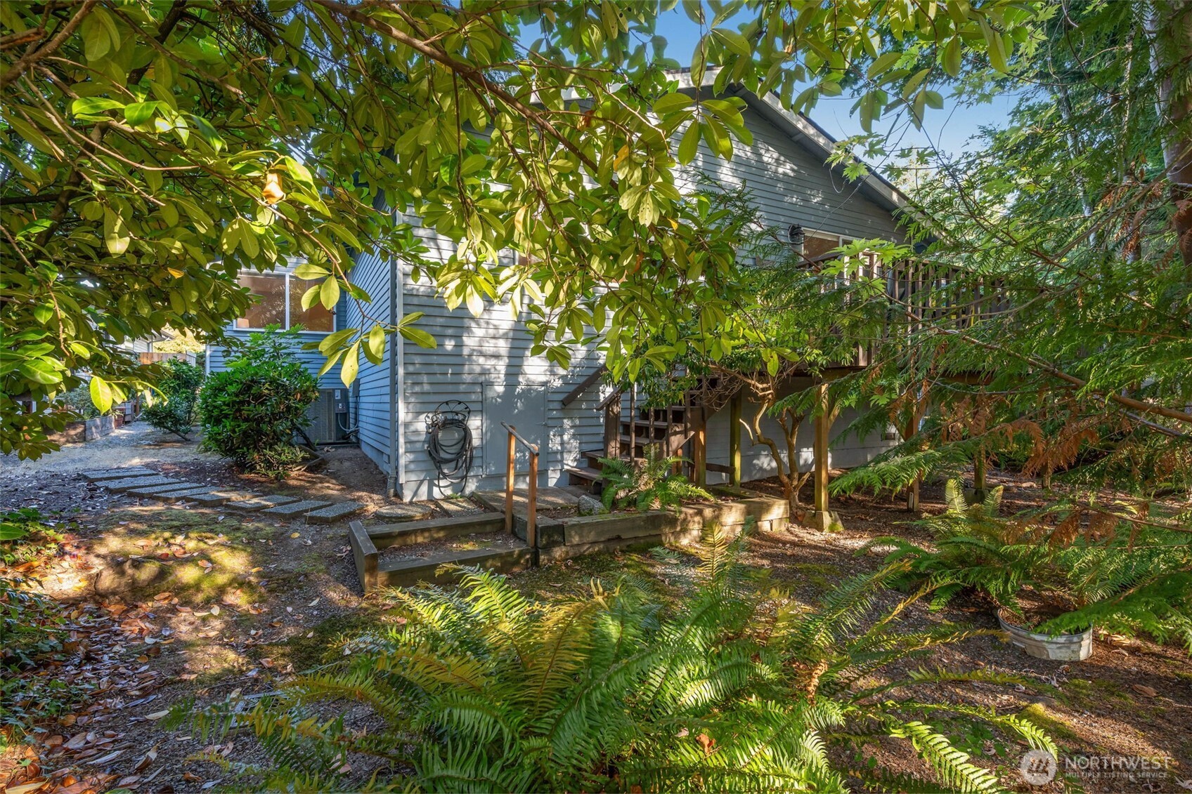 24431 11th Avenue South Des Moines, WA 98198 - Photo 29 of 39 a backyard of a house with table and chairs under an umbrella