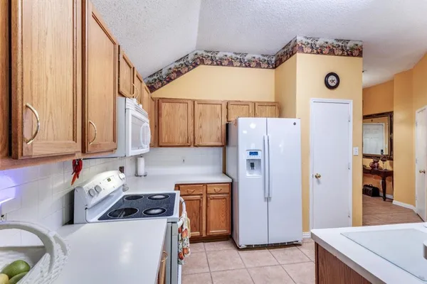 a kitchen with a refrigerator and a stove