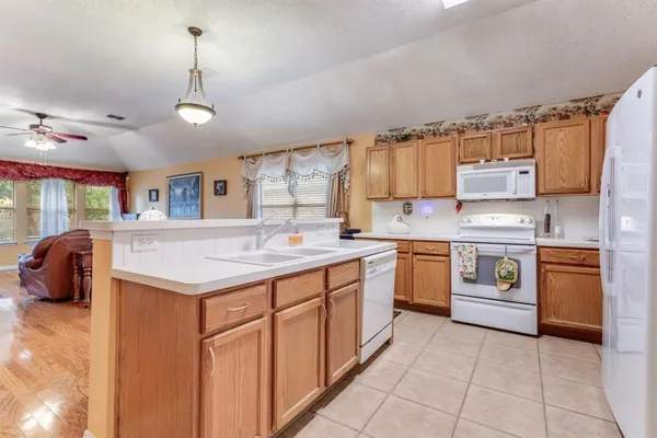 a kitchen with stainless steel appliances a sink stove and cabinets
