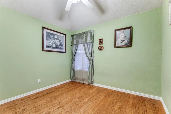 a view of a room with painting on the wall