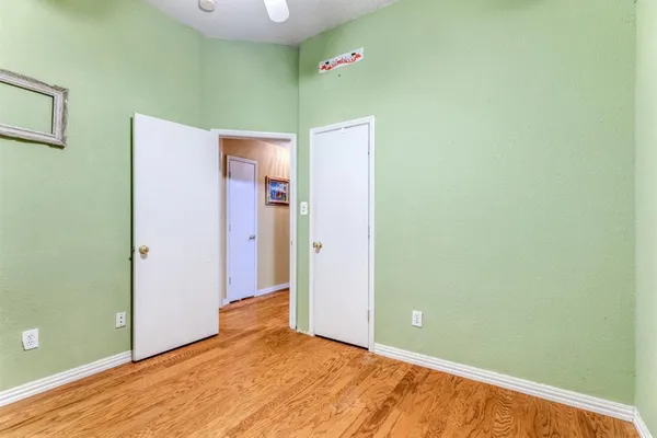 a view of a big room with closet and wooden floor
