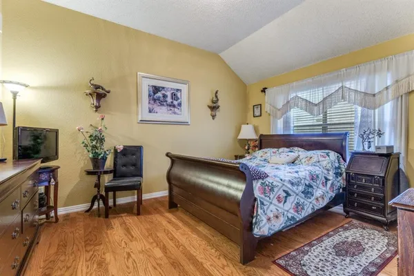 a bedroom with a bed and a chair in it