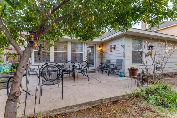 a view of a house with backyard porch and sitting area