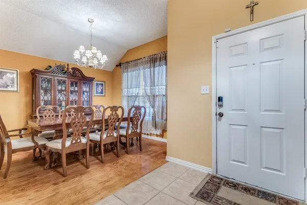 a view of a dining room with furniture a chandelier and wooden floor