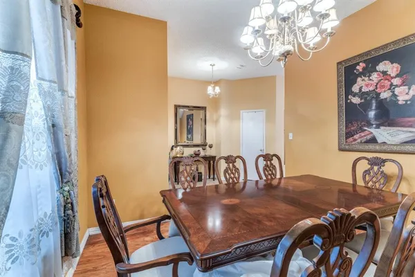 a view of a dining room with furniture and chandelier