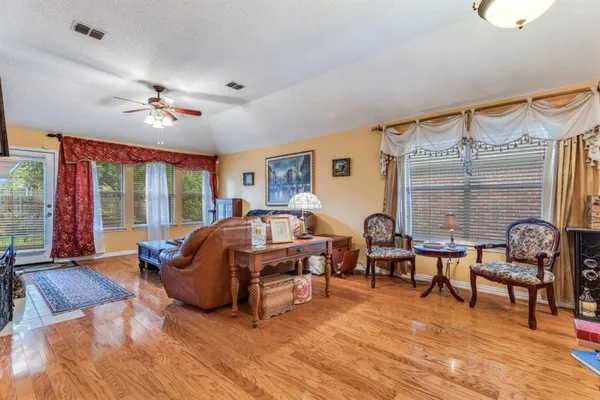 a living room with furniture ceiling fan and a window