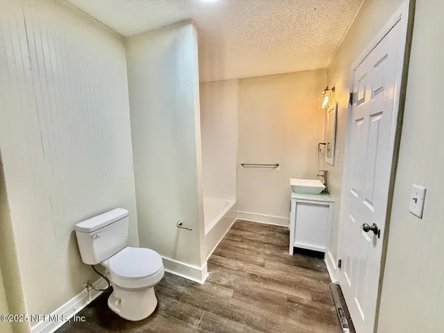 a bathroom with a toilet sink and a shower