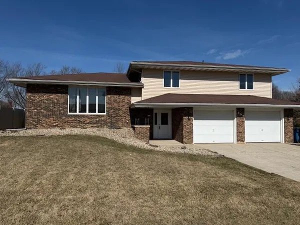 a front view of a house with a garage