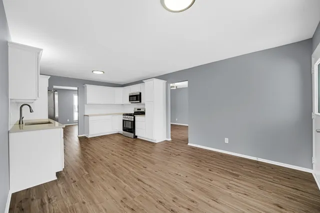 a view of a kitchen with a sink and a refrigerator