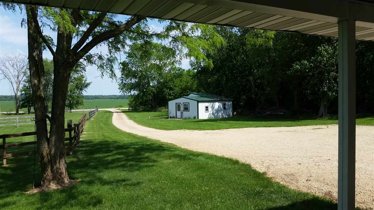 16844 Wheeler Road Durand, IL 61024 - Photo 22 of 22 a view of a garden with a bench in the middle