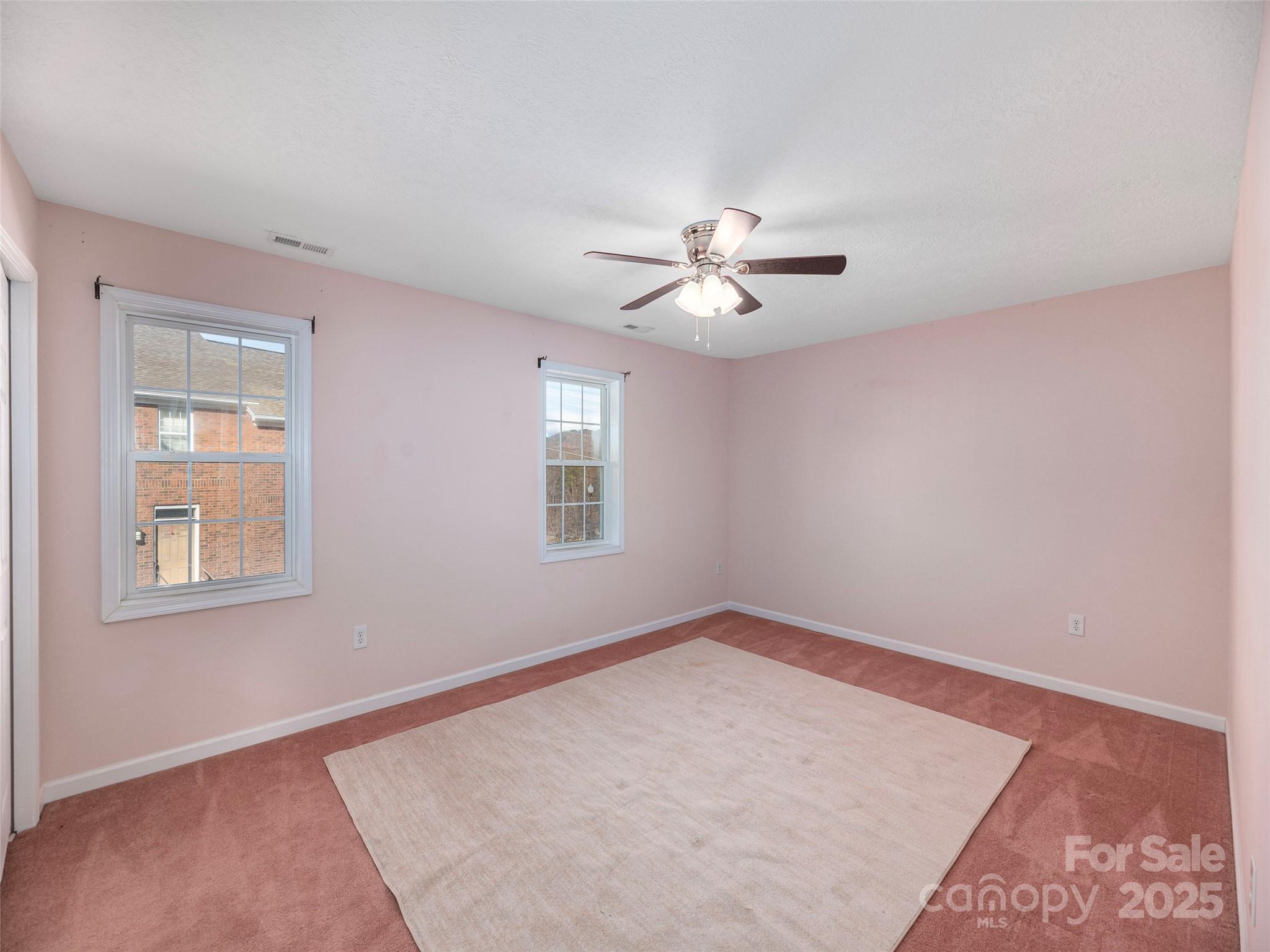 53 Vancott Court Clyde, NC 28721 - Photo 18 of 23 an empty room with windows and ceiling fan