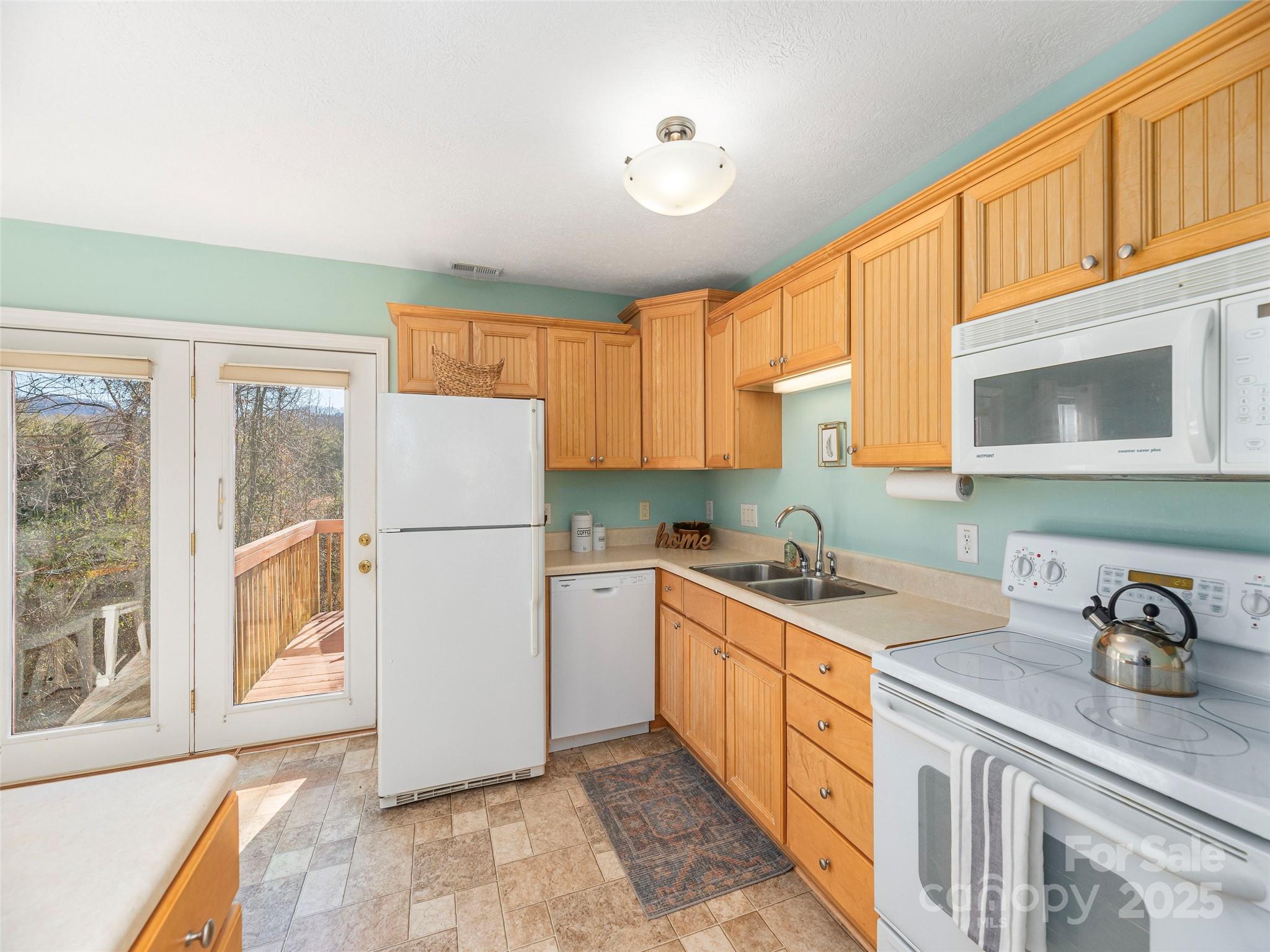 53 Vancott Court Clyde, NC 28721 - Photo 8 of 23 a kitchen with a sink stove and cabinets