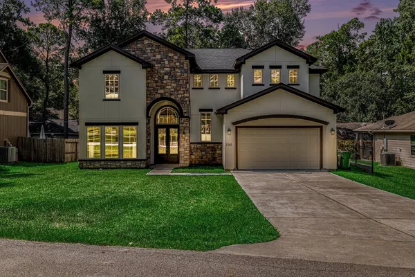 a front view of a house with a yard and garage